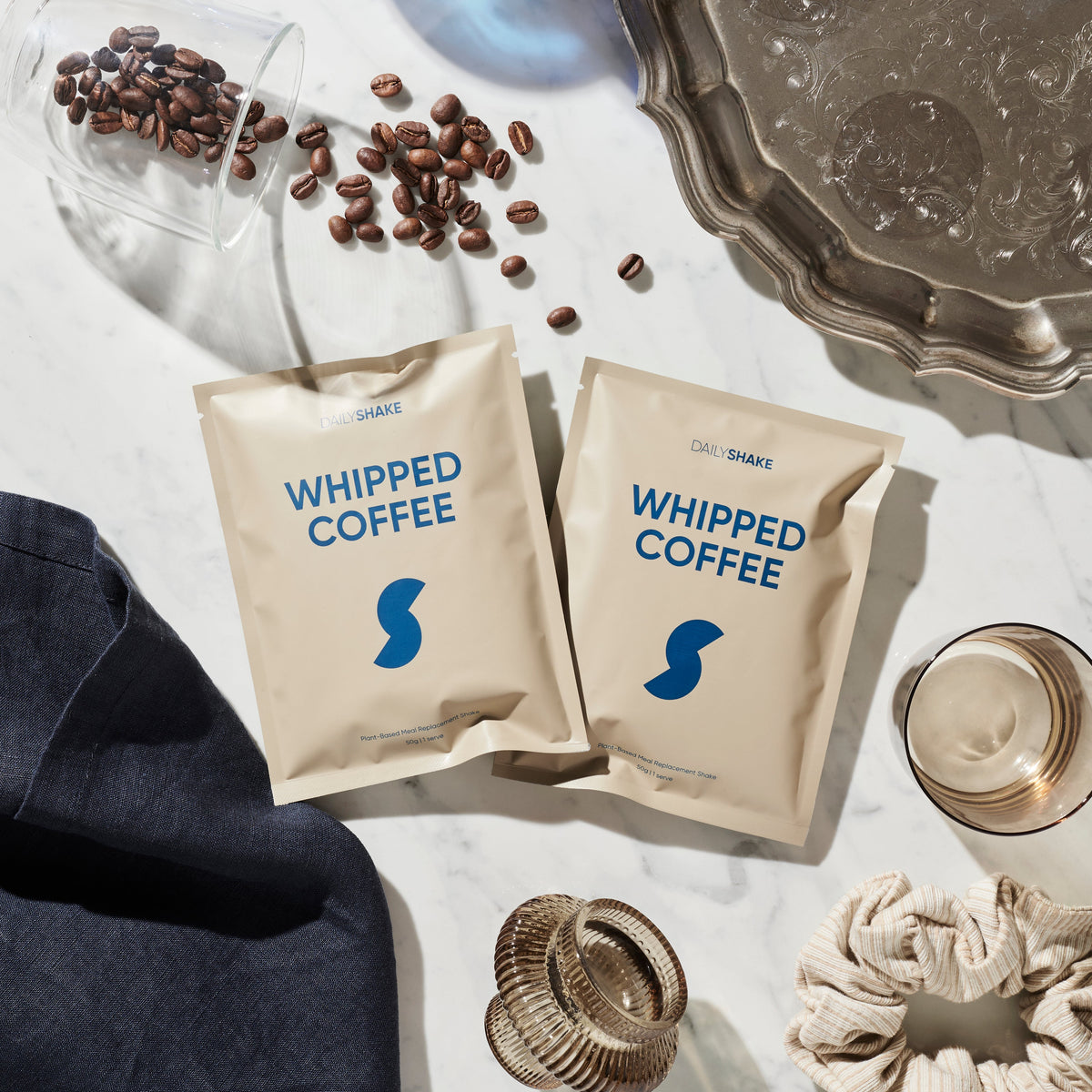 Whipped Coffee Daily Shake sachets and prepared drink